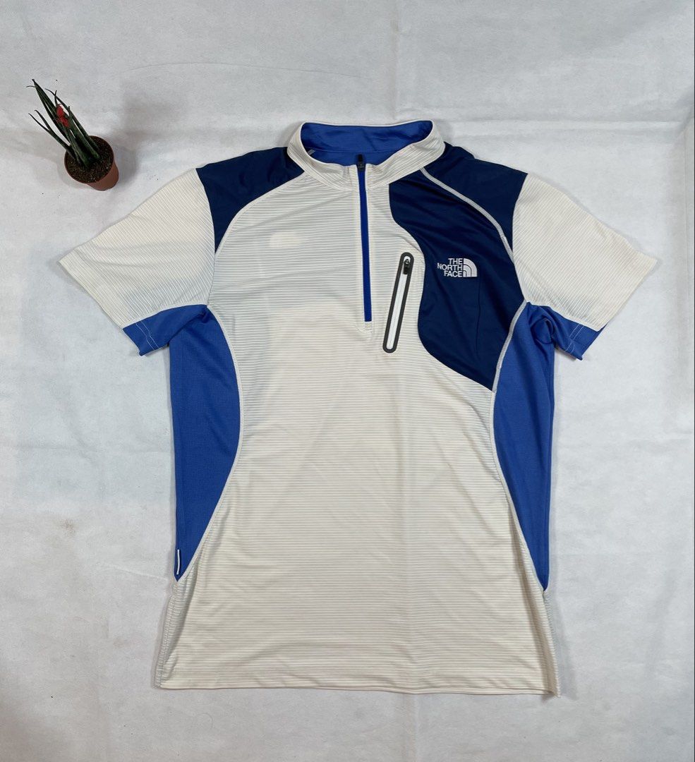 The North Face Functional half-zip athletic shirt (Category: Activewear) located in Bacolod City. Submitted by maxpeynthrift (Listing ID 1458851756, Image 1). Description: Size large W 20 L 27 Excellent condition No issue Drifit Colorblock Style: A contrasting combination of white/cream, royal blue, and deep navy blue panels. Quarter-Zip Closure: Features a high mock neck collar with a partial front zipper. Utility Pocket: A vertical zippered che