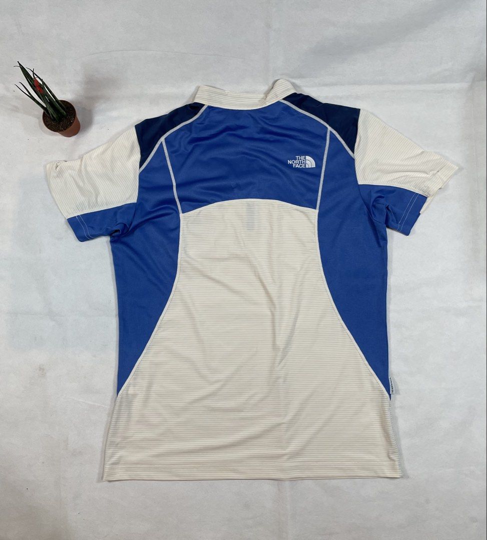 The North Face Functional half-zip athletic shirt (Category: Activewear) located in Bacolod City. Submitted by maxpeynthrift (Listing ID 1458851756, Image 2). Description: Size large W 20 L 27 Excellent condition No issue Drifit Colorblock Style: A contrasting combination of white/cream, royal blue, and deep navy blue panels. Quarter-Zip Closure: Features a high mock neck collar with a partial front zipper. Utility Pocket: A vertical zippered che