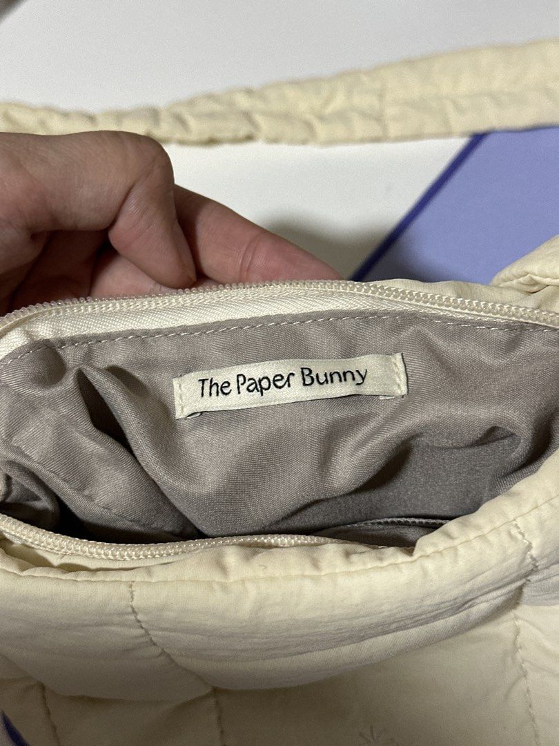 The Paper Bunny Mini Puffer Swing - Cream (Category: Cross-body Bags) located in Pasig City. Submitted by tinqsalazar (Listing ID 1458808442, Image 2). Description: - Authentic The Paper Bunny Mini Puffer Swing - Classic cream / ivory color; super versatile and easy to style - Lightweight, soft & puffy quilted design - Adjustable padded strap for comfortable crossbody wear - Overall in good condition; clean and well-kept - Flaw on the strap buckl