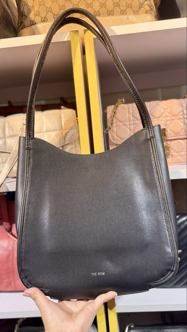 The Row Symmetric Leather Shoulder Bag (Category: Luxury Bags & Wallets) located in Rodriguez. Submitted by PrelovedbyMelz (Listing ID 1458710019, Image 1). Description: The Row bag - Made in Italy - Genuine leather - Spacious interior with pockets - Classic design - Great for everyday use.
