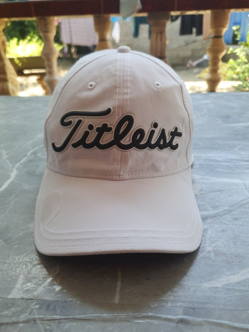 Titleist Golf Cap Hat (Category: Caps & Hats) located in Manila. Submitted by mysticturtle_2f88e1 (Listing ID 1458734330, Image 1). Description: - Classic Titleist golf cap - Light beige and white colorway - Embroidered Titleist logo on front - "Golf's Symbol of Excellence" tagline inside - Adjustable strap for a comfortable fit - Ideal for golf or casual wear.