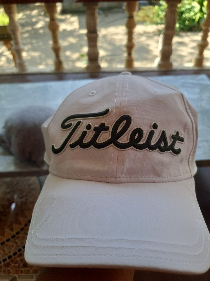 Titleist Golf Cap Hat (Category: Caps & Hats) located in Manila. Submitted by mysticturtle_2f88e1 (Listing ID 1458734330, Image 2). Description: - Classic Titleist golf cap - Light beige and white colorway - Embroidered Titleist logo on front - "Golf's Symbol of Excellence" tagline inside - Adjustable strap for a comfortable fit - Ideal for golf or casual wear.
