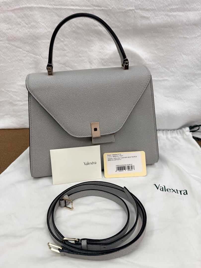 Valextra Iside Medium Bag - Pebble Grey (Complete Set) (Category: Luxury Bags & Wallets) located in Pasay City. Submitted by netuy (Listing ID 1458728497, Image 1). Description: Brand: Valextra (Made in Italy) Model: Iside Medium Material: 100% Textured Calf Leather (highly scratch-resistant) Color: Pebble Grey with Black Costa hand-lacquered edges Hardware: Light gold-tone / Champagne gold👜 Condition:Excellent pre-loved condition Well-structure