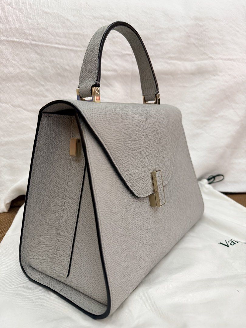 Valextra Iside Medium Bag - Pebble Grey (Complete Set) (Category: Luxury Bags & Wallets) located in Pasay City. Submitted by netuy (Listing ID 1458728497, Image 2). Description: Brand: Valextra (Made in Italy) Model: Iside Medium Material: 100% Textured Calf Leather (highly scratch-resistant) Color: Pebble Grey with Black Costa hand-lacquered edges Hardware: Light gold-tone / Champagne gold👜 Condition:Excellent pre-loved condition Well-structure
