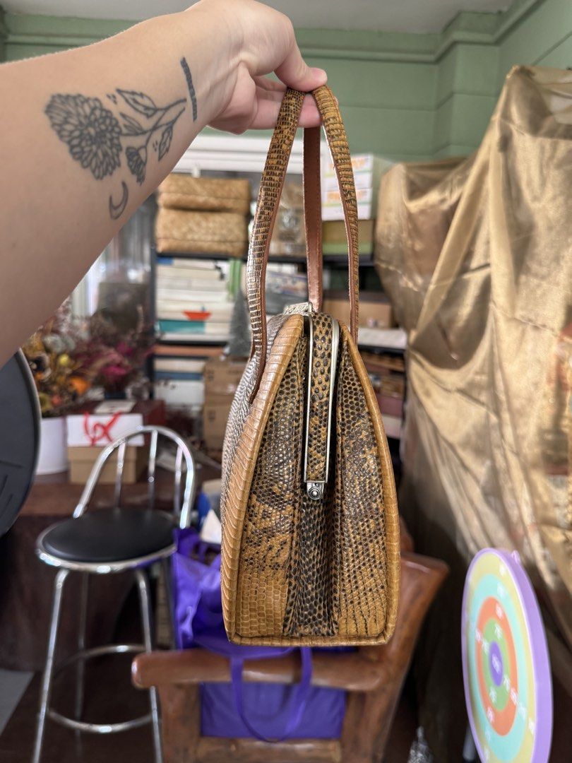 Vintage Brown Lizard Skin Handbag (Category: Purses & Pouches) located in Bacoor. Submitted by nicafindssince2022 (Listing ID 1458689811, Image 2). Description: - Cute vintage handbag - Brown lizard skin texture - Clasp closure - Top handles for carrying - Perfect for a retro vibe - Approx. 10 inches wide - Approx. 6 inches tall.