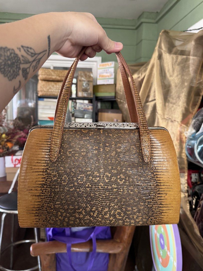 Vintage Brown Lizard Skin Handbag (Category: Purses & Pouches) located in Bacoor. Submitted by nicafindssince2022 (Listing ID 1458689811, Image 1). Description: - Cute vintage handbag - Brown lizard skin texture - Clasp closure - Top handles for carrying - Perfect for a retro vibe - Approx. 10 inches wide - Approx. 6 inches tall.