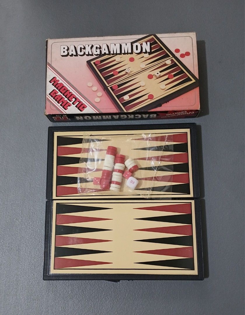 Vintage Magnetic Backgammon Travel Board Game (Category: Board Games & Puzzles) located in Bulacan. Submitted by honhonliz (Listing ID 1458755430, Image 1). Description: This is a complete, vintage pocket-sized magnetic Backgammon game featuring a folding board that doubles as a storage case. The set includes a cream-colored retro cardboard box with red lettering, a hinged black plastic playing board with red and black triangles, a sealed plastic
