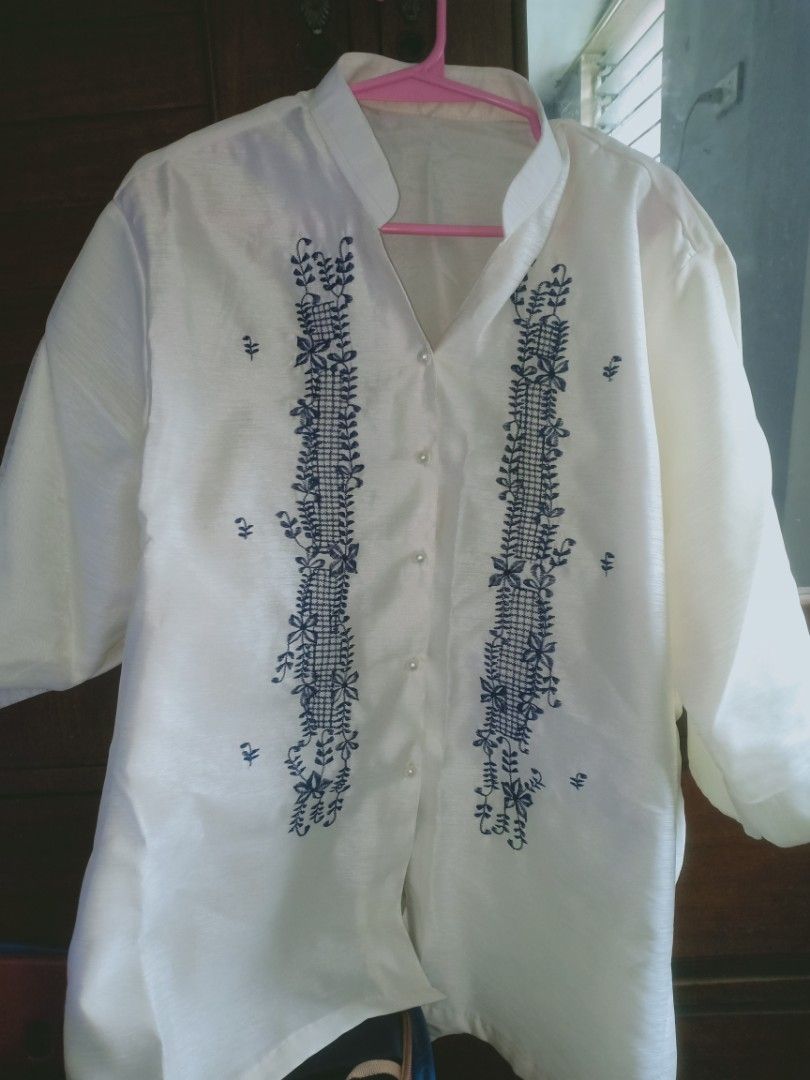 White Barong Tagalog with Blue Embroidery (Category: Formal Shirts) located in Manila. Submitted by macchi1216 (Listing ID 1458698959, Image 1). Description: - Classic white Barong Tagalog - Intricate blue embroidery on front panels - Mandarin collar with pearl button closure - Lightweight fabric for comfort - Ideal for formal events and cultural celebrations - Sharp, traditional look.
