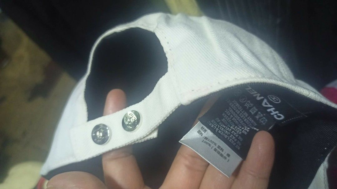 White Chanel Cap (Category: Luxury Accessories) located in Baguio. Submitted by XycerlynCLXN (Listing ID 1458801171, Image 2). Description: - White baseball cap - Features a gold Chanel logo - Adjustable strap at the back for a custom fit - Perfect for sunny days - Clean and ready to wear.