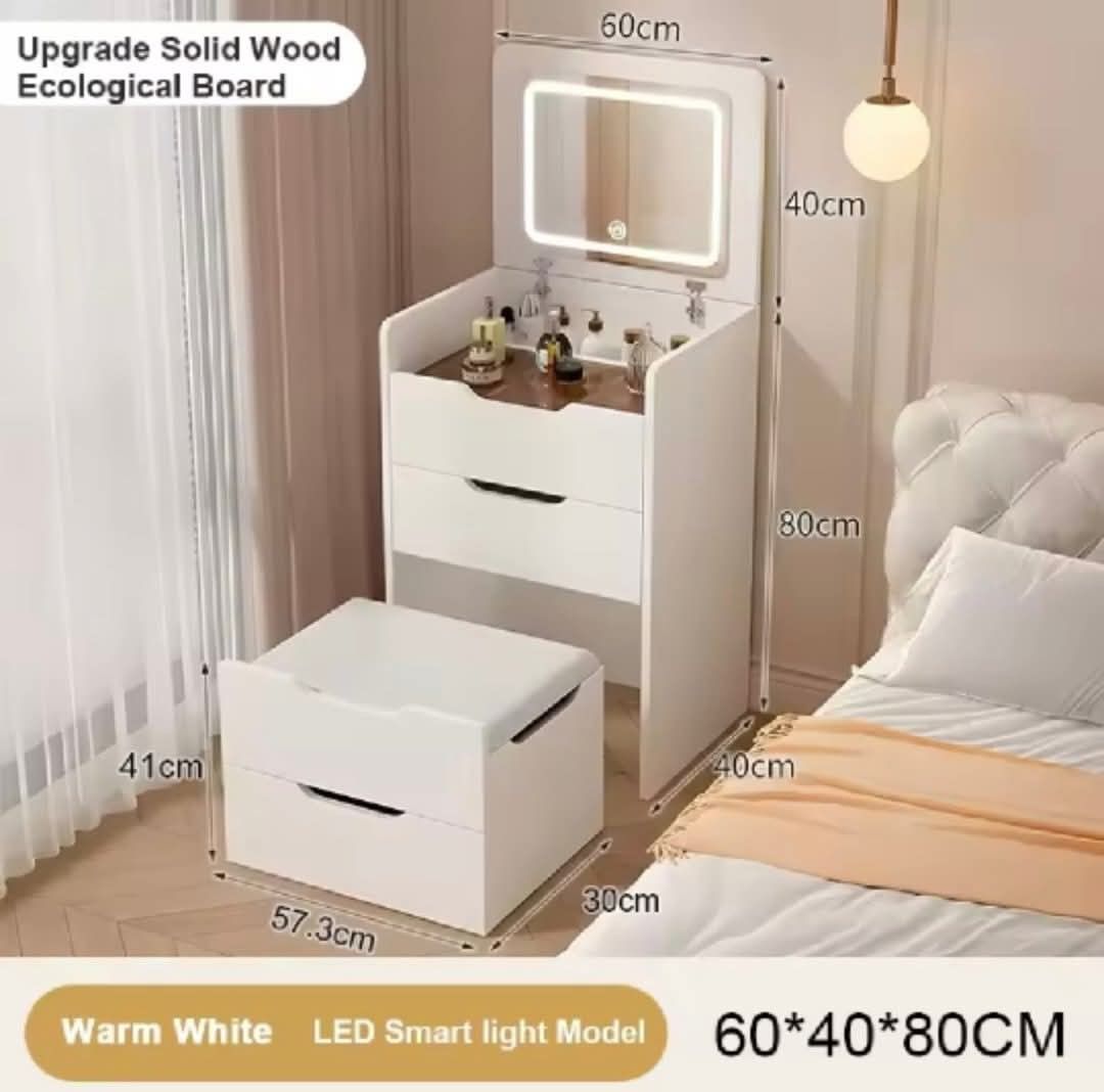 White LED Vanity Table with Mirror and Storage (Category: Tables & Sets) located in Mandaluyong City. Submitted by carmy.94 (Listing ID 1458884439, Image 2). Description: - Stylish white dressing table with integrated LED mirror - Multiple drawers for generous storage - Top compartment with dividers for makeup organization - Crafted from durable ecological board - Compact dimensions: 60cm (L) x 40cm (W) x 80cm (H) - Comes with a matching stool.