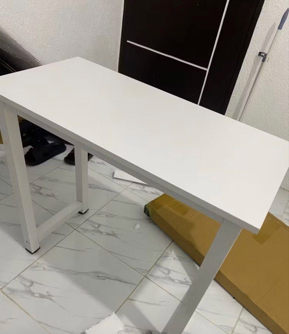 White Study Desk / Computer Table 80x40x74cm (Category: Tables & Sets) located in Rizal. Submitted by declutteryarn (Listing ID 1458869189, Image 3). Description: - Simple white desk, perfect for studying or working from home. - Dimensions: 80cm (W) x 40cm (L) x 74cm (H). - Easy to assemble and very sturdy. - Ideal for small spaces. - Selling because I upgraded to a new desk. - With minimal scratches on foot but doesn't affect performance bought 