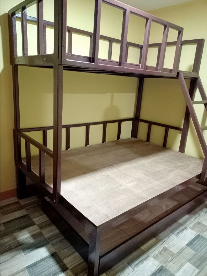 Wooden Bunk Bed with Drawers and Pull-out Beds (Category: Bed Frames & Mattresses) located in Caloocan City. Submitted by newcat-ca23 (Listing ID 1458722105, Image 1). Description: - Solid wood bunk bed - Available in white or dark wood finish - Features two stacked beds with a ladder for access - White bunk bed includes two convenient storage drawers underneath - Excellent space-saving solution - Sturdy and durable construction - Ideal for child
