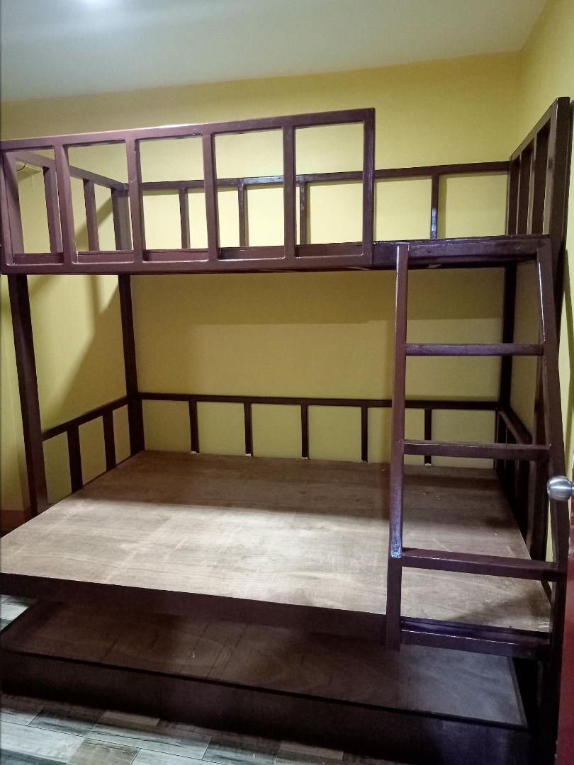 Wooden Bunk Bed with Drawers and Pull-out Beds (Category: Bed Frames & Mattresses) located in Caloocan City. Submitted by newcat-ca23 (Listing ID 1458722105, Image 2). Description: - Solid wood bunk bed - Available in white or dark wood finish - Features two stacked beds with a ladder for access - White bunk bed includes two convenient storage drawers underneath - Excellent space-saving solution - Sturdy and durable construction - Ideal for child