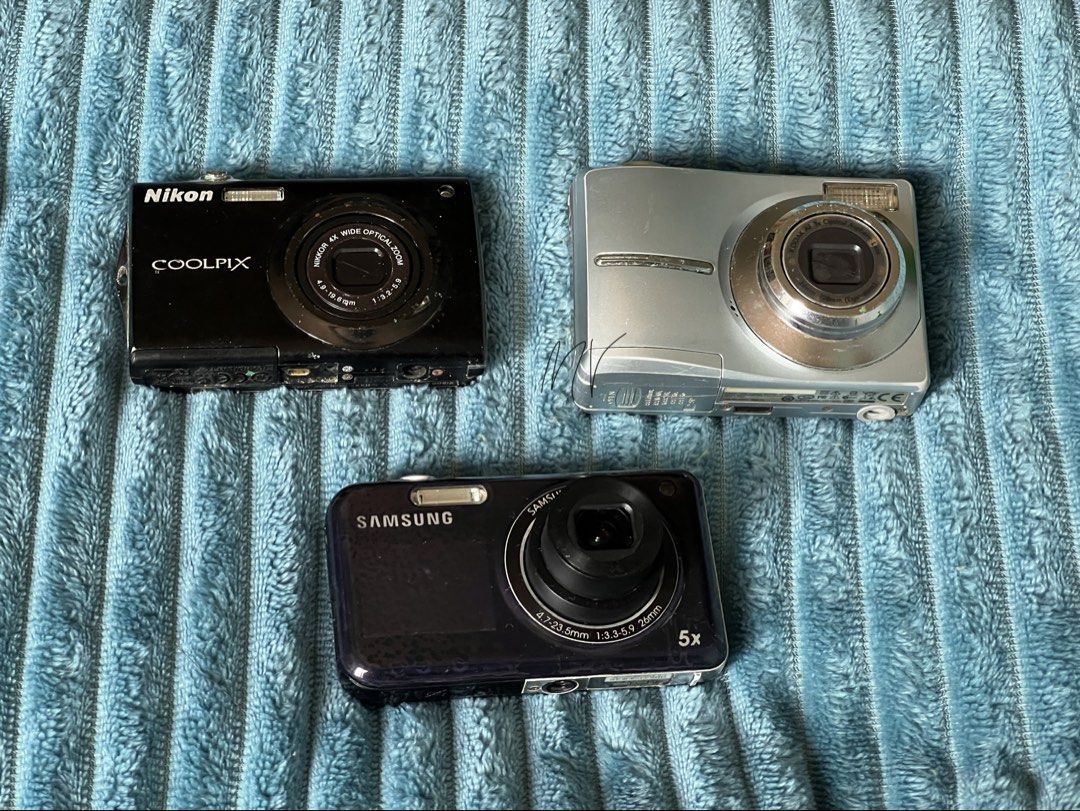 Working digicams with functional issues (Category: Cameras) located in Manila. Submitted by astathis (Listing ID 1458782689, Image 1). Description: ~Still negotiable~ For TAKE-ALL: ▪️Samsung PL120 -w/battery -5x Zoom Lens -4.7-23.5mm -with front screen -issue: AF dysfunctional ▪️Nikon Coolpix -w/ battery -Nikkor 4x Wide Optical Zoom -4.9-19.6mm -issue: battery error & touchscreen not working ▪️Kodak EasyShare C913 -double AA battery -Kodak AF 3x 