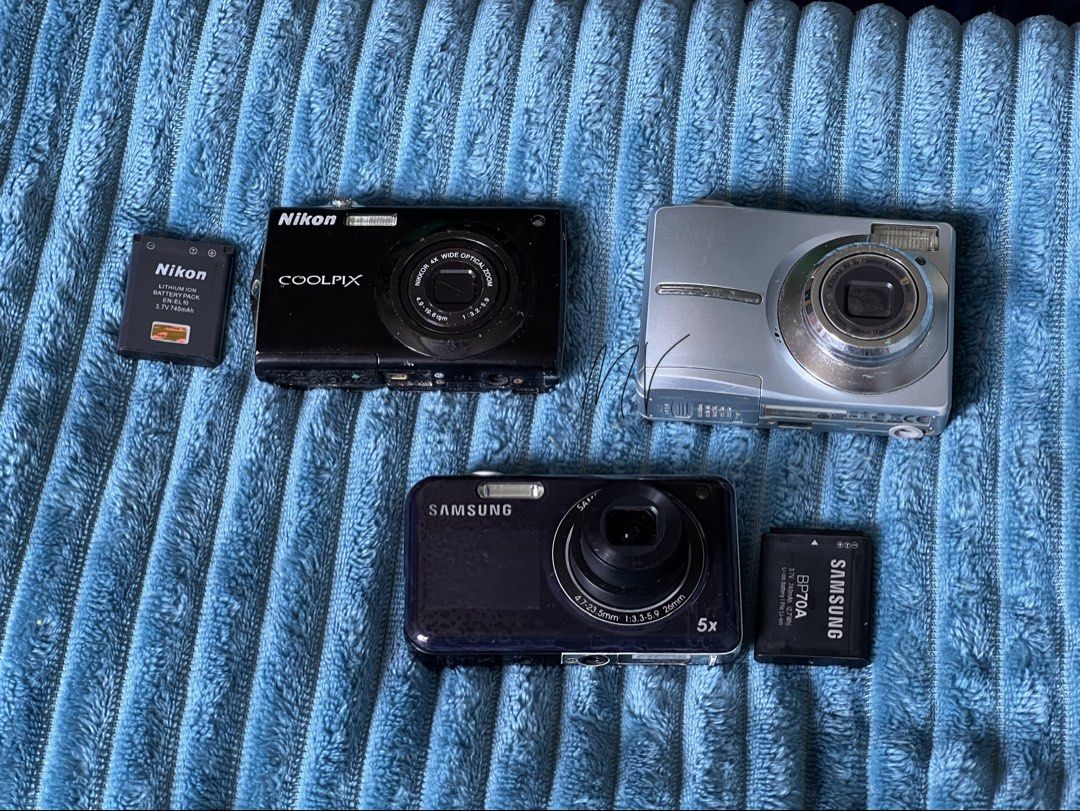Working digicams with functional issues (Category: Cameras) located in Manila. Submitted by astathis (Listing ID 1458782689, Image 2). Description: ~Still negotiable~ For TAKE-ALL: ▪️Samsung PL120 -w/battery -5x Zoom Lens -4.7-23.5mm -with front screen -issue: AF dysfunctional ▪️Nikon Coolpix -w/ battery -Nikkor 4x Wide Optical Zoom -4.9-19.6mm -issue: battery error & touchscreen not working ▪️Kodak EasyShare C913 -double AA battery -Kodak AF 3x 