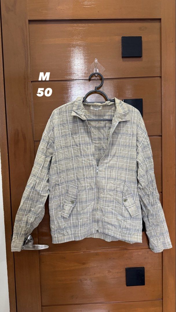 World Top Plaid Zip-Up Jacket Size M (Category: Coats, Jackets and Outerwear) located in Makati City. Submitted by deadseaaa (Listing ID 1458775232, Image 1). Description: - World Top Plaid Zip-Up Jacket - Size: Medium (M) - Classic neutral plaid pattern - Two front pockets with button closures - Full zipper closure - Ideal for layering and casual styling.