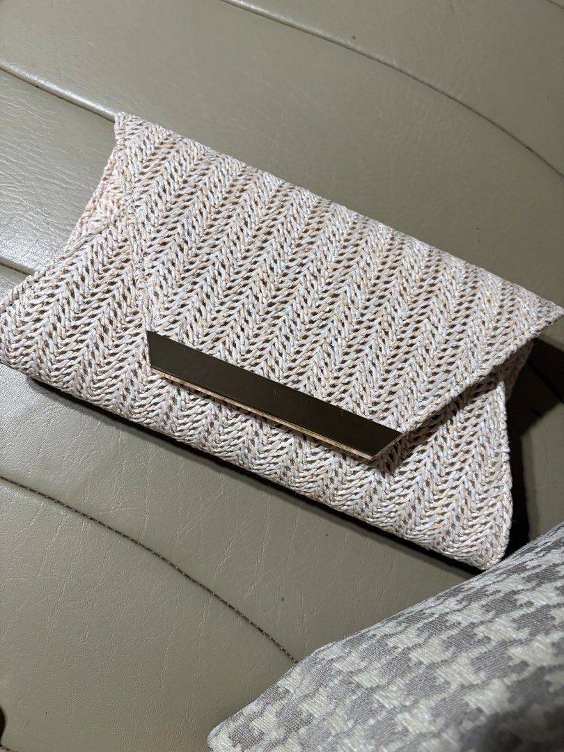 Woven Envelope Clutch Bag with Gold Clasp (Category: Clutches) located in Makati City. Submitted by panikki (Listing ID 1458704403, Image 1). Description: - Cute woven clutch bag - Natural straw-like material with chevron pattern - Gold metal accent on flap closure - Interior small pocket - Magnetic snap closure - Ideal for evenings out or special occasions Used once for an event .