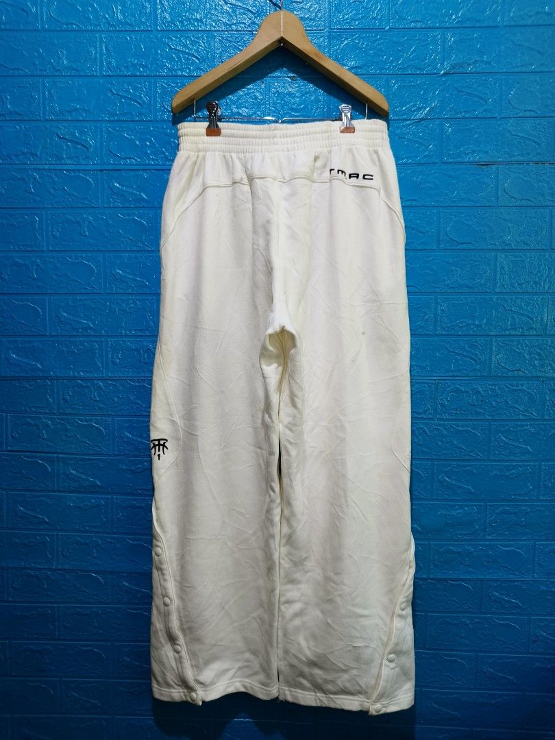 Y2k Adidas TMAC White Snap Button Track Pants Size M (Category: Joggers) located in Davao. Submitted by vndrgd (Listing ID 1458802688, Image 3). Description: - White Adidas TMAC track pants - Size: Medium (fits waist 30-34 inches) - Measurements: Length 41 inches, Hem 10.5 inches - Features: Snap buttons down the sides - Condition: Minor marks on fabric (please check photos) - Ideal for: Casual wear or sports.