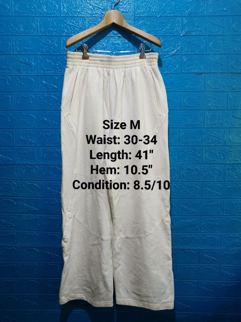 Y2k Adidas TMAC White Snap Button Track Pants Size M (Category: Joggers) located in Davao. Submitted by vndrgd (Listing ID 1458802688, Image 1). Description: - White Adidas TMAC track pants - Size: Medium (fits waist 30-34 inches) - Measurements: Length 41 inches, Hem 10.5 inches - Features: Snap buttons down the sides - Condition: Minor marks on fabric (please check photos) - Ideal for: Casual wear or sports.