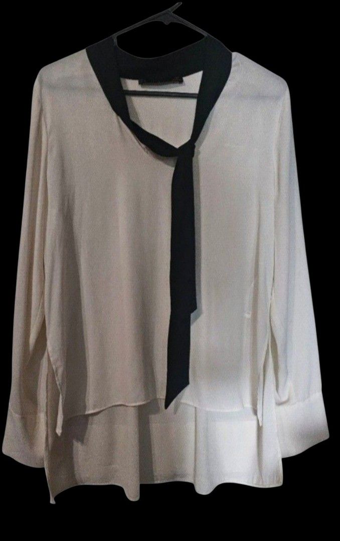 Zara Basic White Long Sleeve Blouse with Black Collar and Tie (Category: Blouses) located in Quezon City. Submitted by kcobs (Listing ID 1458834546, Image 1). Description: - White long-sleeved blouse from Zara Basic - Features a contrasting black collar - Front tie detail - Subtle pleats on the back - Perfect for dressing up or down - Ideal for work or casual outings.