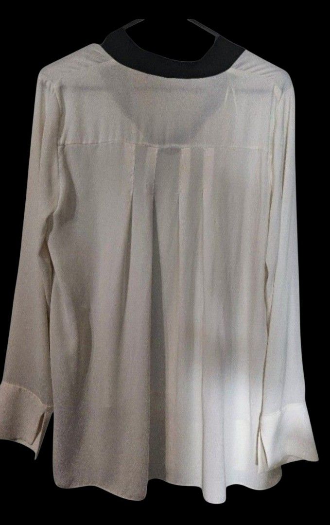 Zara Basic White Long Sleeve Blouse with Black Collar and Tie (Category: Blouses) located in Quezon City. Submitted by kcobs (Listing ID 1458834546, Image 2). Description: - White long-sleeved blouse from Zara Basic - Features a contrasting black collar - Front tie detail - Subtle pleats on the back - Perfect for dressing up or down - Ideal for work or casual outings.