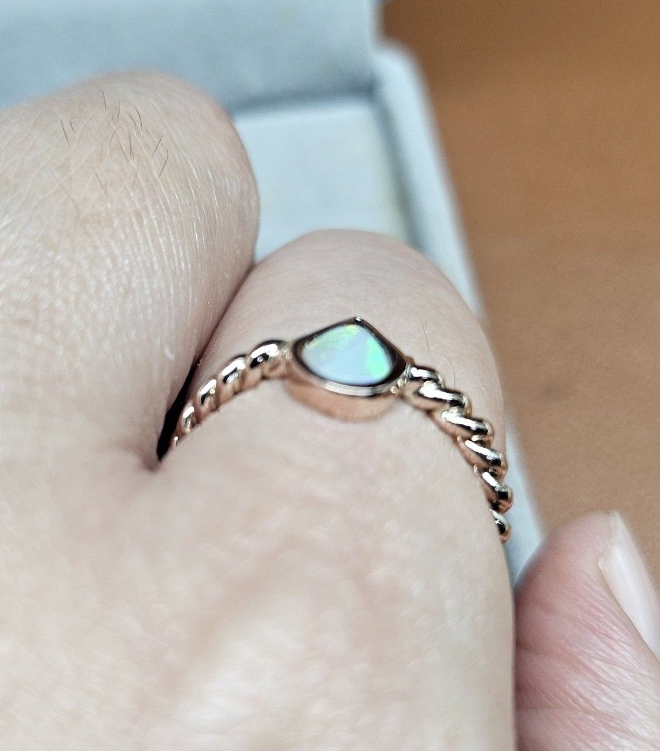 14K Rose Gold Twisted Band Pear Cut Opal Ring (Category: Rings) located in Cebu City. Submitted by isaira (Listing ID 1453725801, Image 2). Description: - 14k pawnable Rose Gold (2.4 grams) - size 5 & 1/2 - Cute pear-cut opal ring - Rose gold twisted band - Lovely iridescent shimmer - Great for stacking or wearing alone - Simple and dainty design - Perfect for everyday wear.