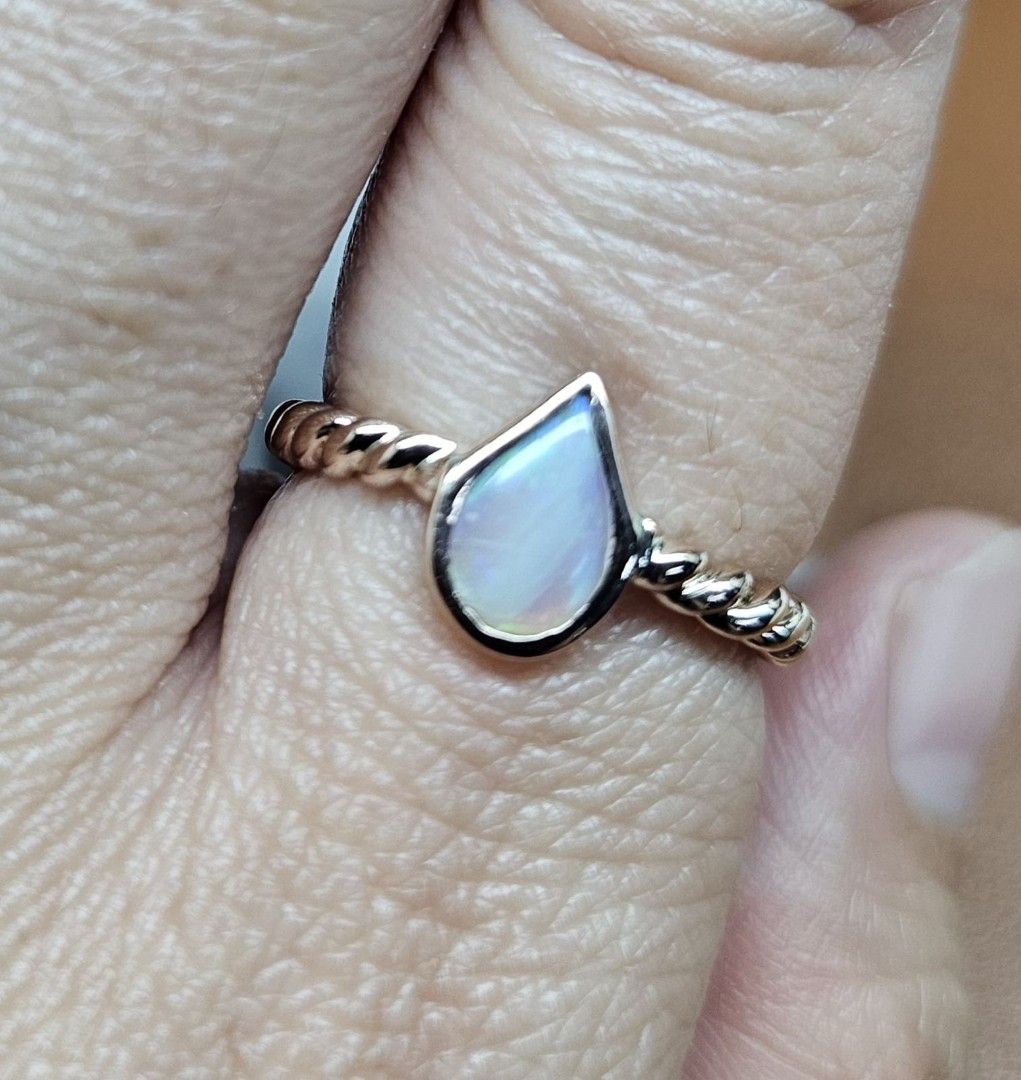14K Rose Gold Twisted Band Pear Cut Opal Ring (Category: Rings) located in Cebu City. Submitted by isaira (Listing ID 1453725801, Image 3). Description: - 14k pawnable Rose Gold (2.4 grams) - size 5 & 1/2 - Cute pear-cut opal ring - Rose gold twisted band - Lovely iridescent shimmer - Great for stacking or wearing alone - Simple and dainty design - Perfect for everyday wear.