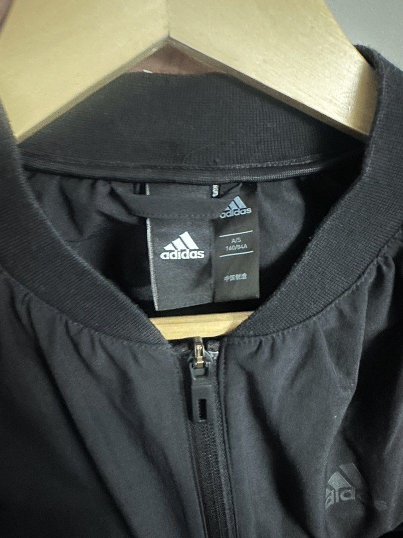 Adidas Black Bomber Jacket with Stripes (Category: Coats, Jackets and Outerwear) located in Manila. Submitted by madysss (Listing ID 1453779016, Image 3). Description: Bestfit: M-semi L - Classic Adidas bomber jacket - Iconic Adidas logo on chest - Ribbed cuffs and hem with signature stripes - Full zipper closure - Versatile for casual wear or light workouts.