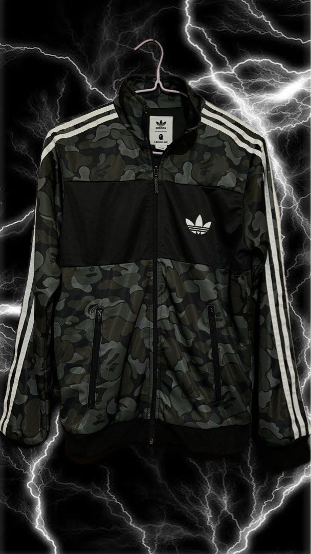 Adidas x A Bathing Ape Camo Track Jacket (Category: Activewear) located in Butuan. Submitted by jnk03 (Listing ID 1453756394, Image 2). Description: - Adidas x A Bathing Ape collaboration - Stylish camouflage pattern - Iconic Adidas 3-Stripes on sleeves - Full zip-up front closure - Convenient front pockets - Versatile for casual wear or athletic activities - Unique and eye-catching design.