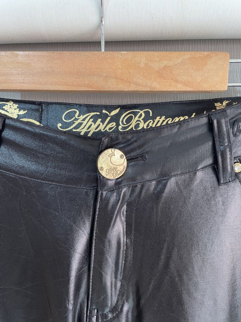 Apple Bottoms Black Faux Leather Pants (Category: Other Bottoms) located in Mataasnakahoy. Submitted by zero4thrift (Listing ID 1453629497, Image 2). Description: - Brand: Apple Bottoms - Material: Faux Leather - Color: Black - Fit: Straight Leg - Details: Gold button accents, embroidered logo on back pockets - Features: Nice sheen, statement piece .