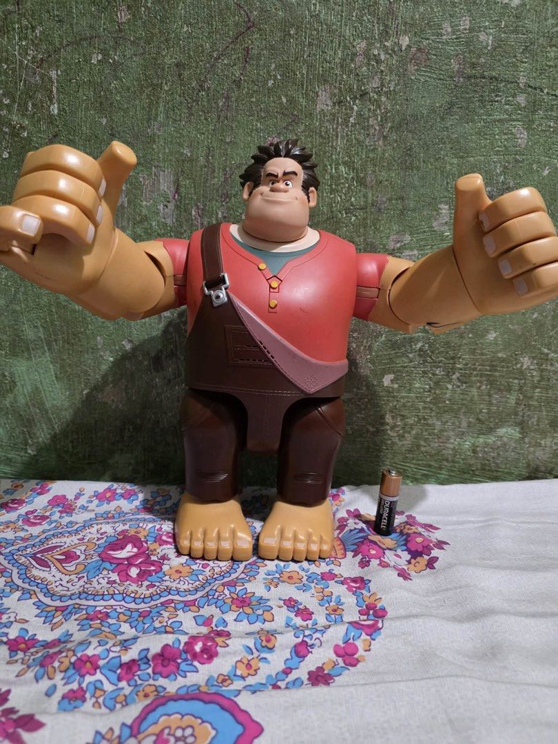 Authentic Disney Thinkway Wreck-It Ralph 11" Talking Action Figure (Category: Figurines & Statues) located in Lapu Lapu. Submitted by luckypenguin_01a640 (Listing ID 1453724609, Image 2). Description: Selling an authentic Disney Wreck-It Ralph Talking & Fist-Pounding Action Figure by Thinkway Toys. Large 11-inch scale collectible Ralph figure with articulated arms, hands, and head. Features smash-action triggers on the back that swing his fists a