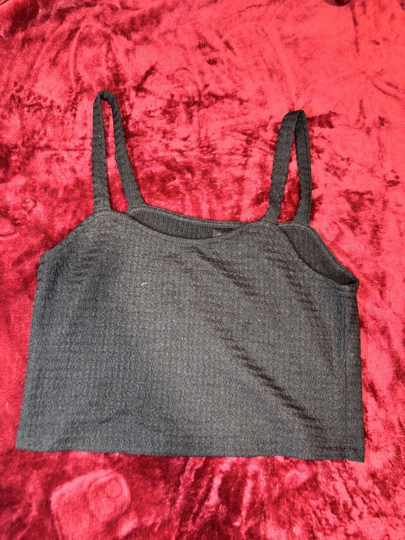 Black Textured Cami Crop Top (Category: Sleeveless) located in Batangas. Submitted by puccagirlypop (Listing ID 1453739202, Image 1). Description: Color: Black Style: Straight neckline cami top with thick fixed shoulder straps and a cropped fit Fabric: Soft, textured/wavy stretch knit Size: Free size (Best fits Small to Medium) A sleek and versatile basic crop top featuring a unique textured finish! Easy to mix and match with high-waisted bottoms