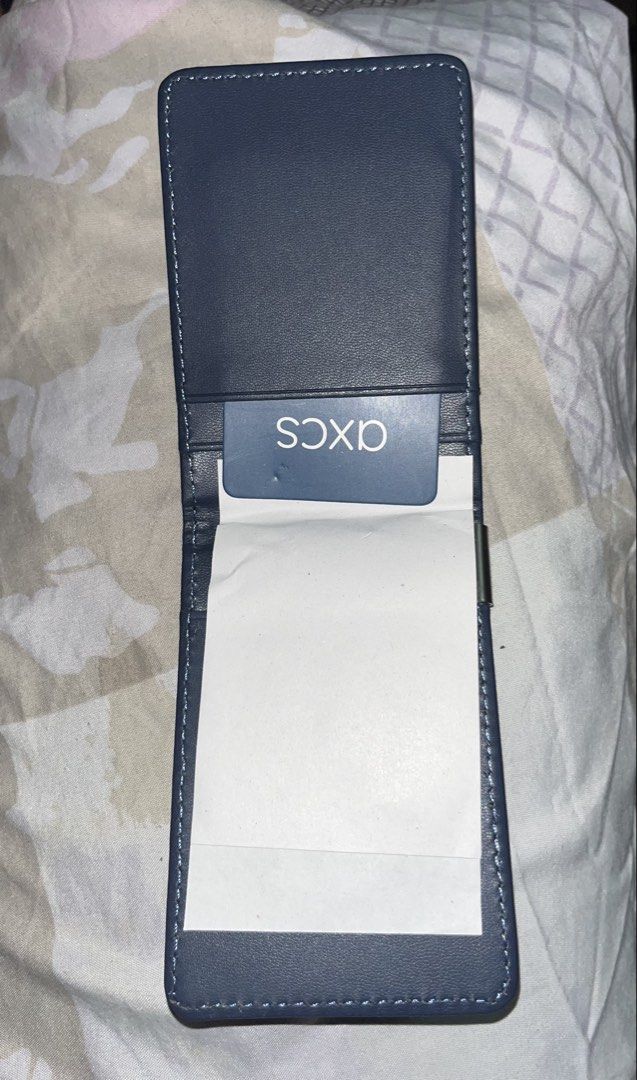 Black Wallet with Money Clip (Category: Wallets & Card Holders) located in Taguig. Submitted by mafrd (Listing ID 1453717751, Image 2). Description: - Black card holder - Features a built-in metal money clip - Comes with a blue card displaying the 'AXCS' logo - Slim and compact design for easy portability.