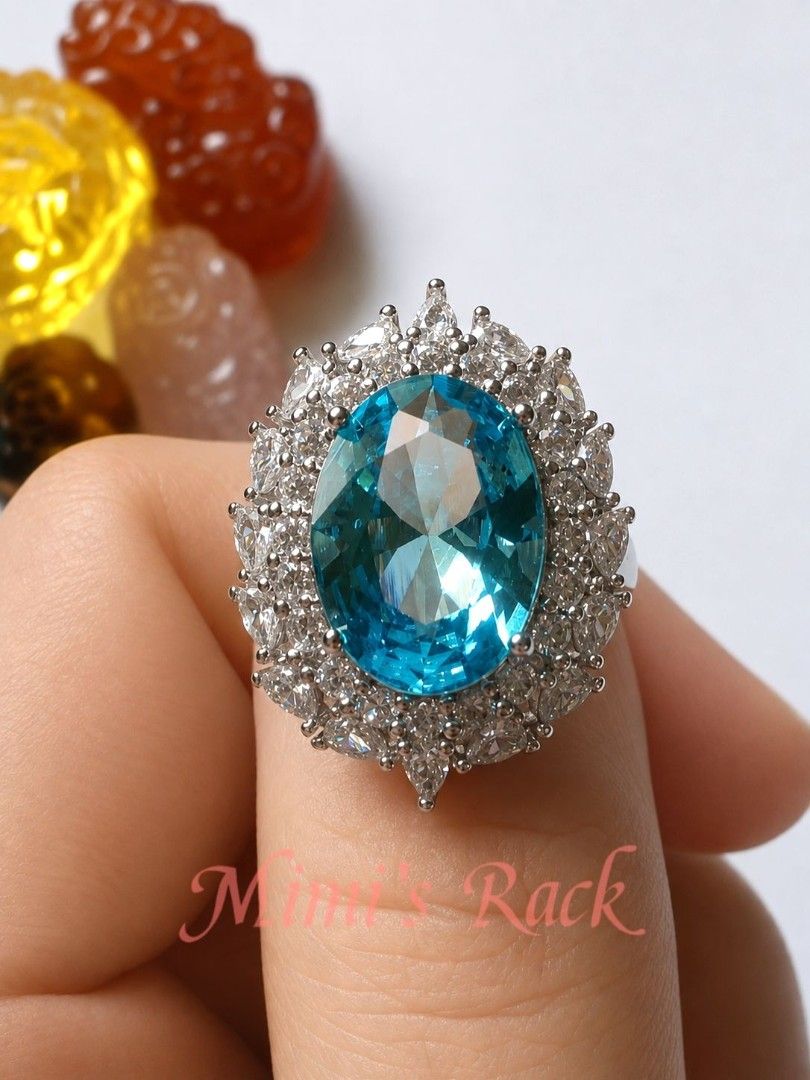 Blue Topaz Halo Statement Ring (Category: Rings) located in Taguig. Submitted by mimisrack (Listing ID 1453764986, Image 1). Description: -A timeless statement ring featuring a dazzling oval-cut blue topaz-inspired centerpiece surrounded by a brilliant halo of sparkling clear stones. Its classic design brings elegance, sophistication, and a touch of royalty to any outfit. -The vibrant blue gemstone catches the light beautifully, displaying brilli