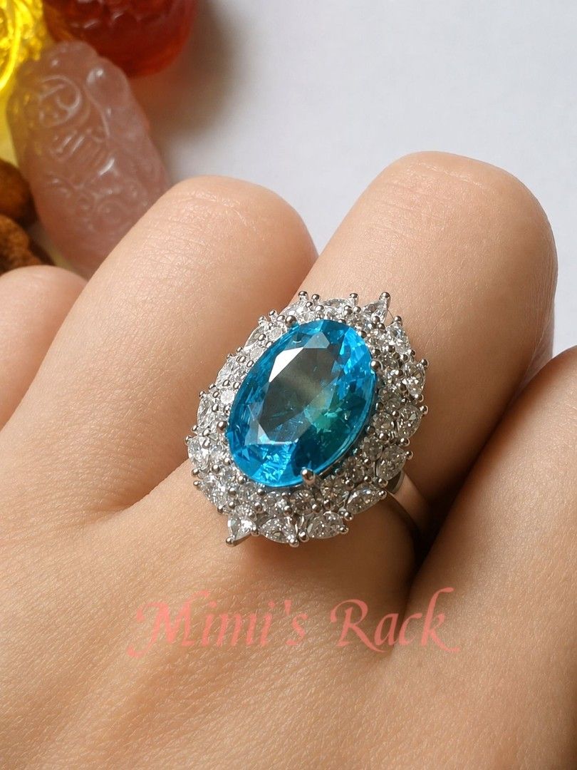 Blue Topaz Halo Statement Ring (Category: Rings) located in Taguig. Submitted by mimisrack (Listing ID 1453764986, Image 2). Description: -A timeless statement ring featuring a dazzling oval-cut blue topaz-inspired centerpiece surrounded by a brilliant halo of sparkling clear stones. Its classic design brings elegance, sophistication, and a touch of royalty to any outfit. -The vibrant blue gemstone catches the light beautifully, displaying brilli