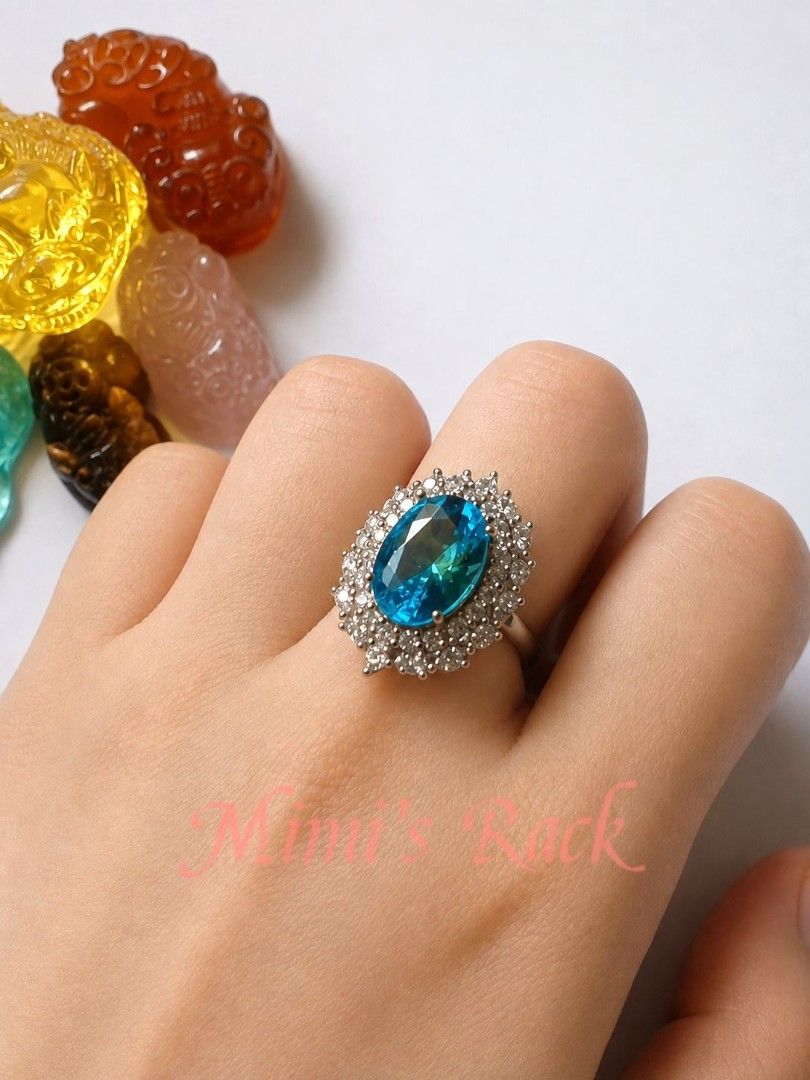 Blue Topaz Halo Statement Ring (Category: Rings) located in Taguig. Submitted by mimisrack (Listing ID 1453764986, Image 3). Description: -A timeless statement ring featuring a dazzling oval-cut blue topaz-inspired centerpiece surrounded by a brilliant halo of sparkling clear stones. Its classic design brings elegance, sophistication, and a touch of royalty to any outfit. -The vibrant blue gemstone catches the light beautifully, displaying brilli