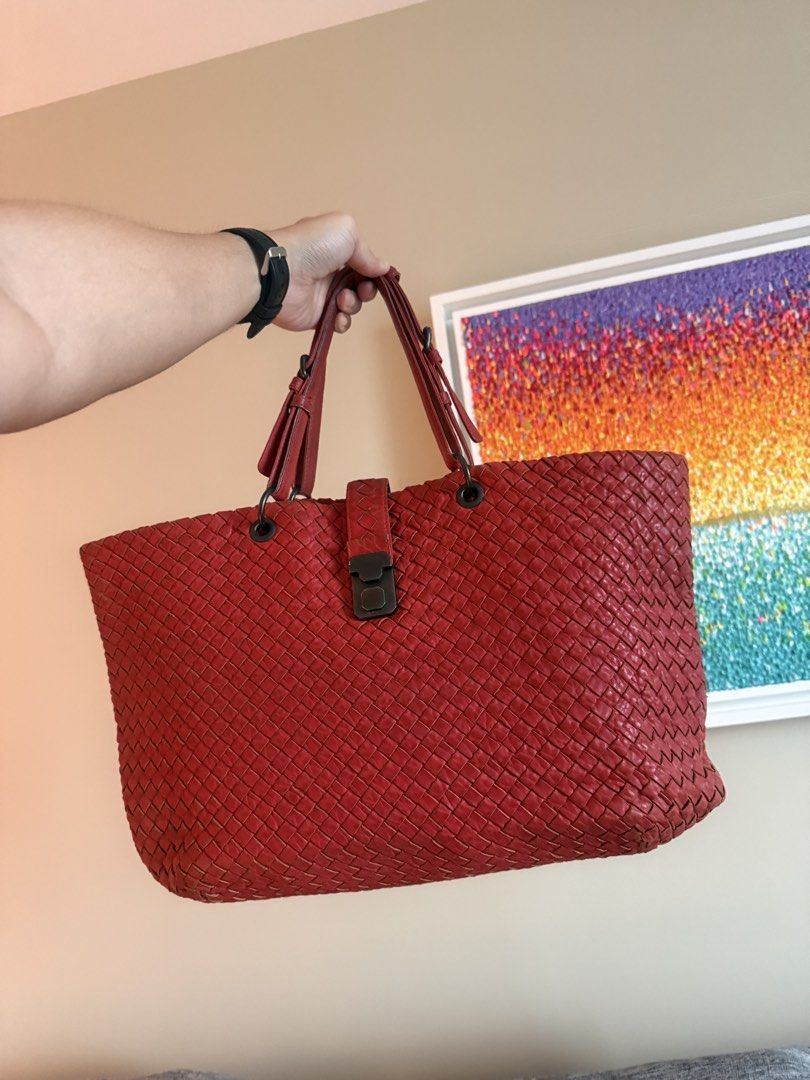 Bottega Venetta Capri (Category: Luxury Bags & Wallets) located in Makati City. Submitted by markussangabriel (Listing ID 1453727561, Image 3). Description: - Unique red woven leather tote bag - Features a distinctive weave pattern - Secure clasp closure at the top - Comfortable straps for easy carrying - Perfect size for daily essentials - Adds a stylish touch to any outfit.