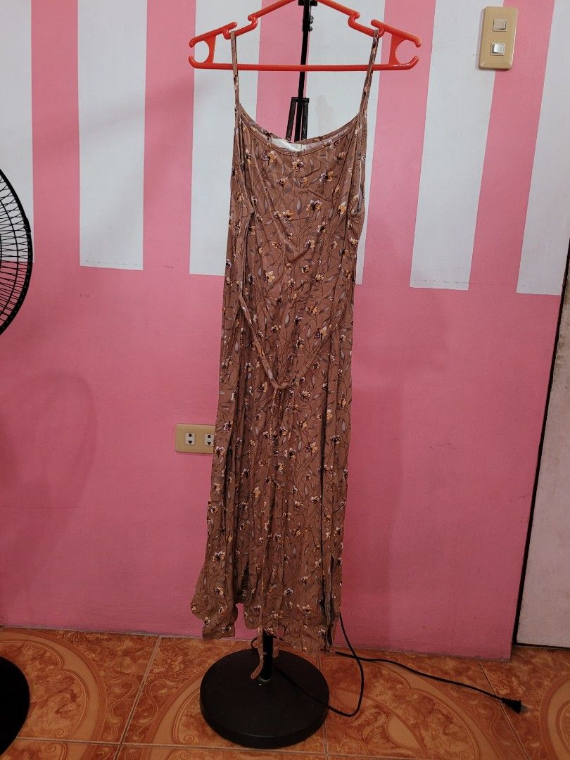 Brown Floral Maxi Dress with Spaghetti Straps (Category: Dresses) located in Mangaldan. Submitted by cha_reyna (Listing ID 1453675729, Image 1). Description: - Brown maxi dress with a delicate floral print - Features thin spaghetti straps - Adjustable tie waist for a flattering fit - Made from flowy, comfortable fabric - Ideal for casual outings, beach days, or relaxed events - Easy to style and wear.