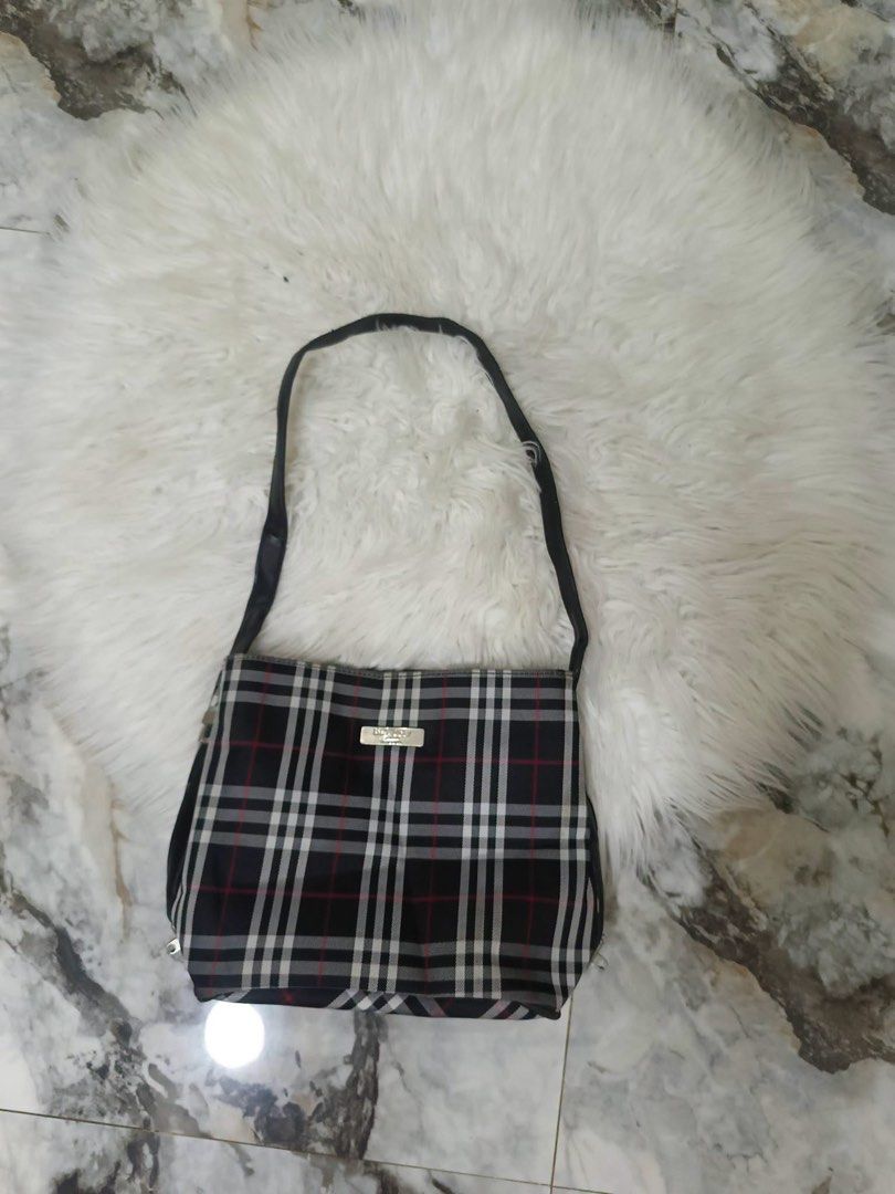Burberry Blue Label Nova Check Shoulder Bag (Category: Luxury Bags & Wallets) located in Kibawe. Submitted by jeloots (Listing ID 1453763310, Image 3). Description: - Authentic Burberry Blue Label shoulder bag - Iconic Nova Check pattern (black, white, red plaid) - Genuine leather strap and trim - Interior: zippered pocket and main compartment - Ideal for everyday use.