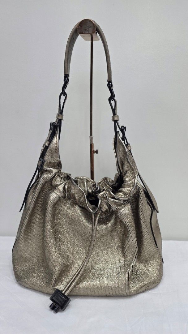 Burberry Metallic Leather Drawstring Hobo Bag (Category: Luxury Bags & Wallets) located in San Fernando. Submitted by bagproject (Listing ID 1453699818, Image 1). Description: - Stunning metallic gold finish - Made from soft, textured leather - Secure drawstring closure with stylish toggle - Good condition.
