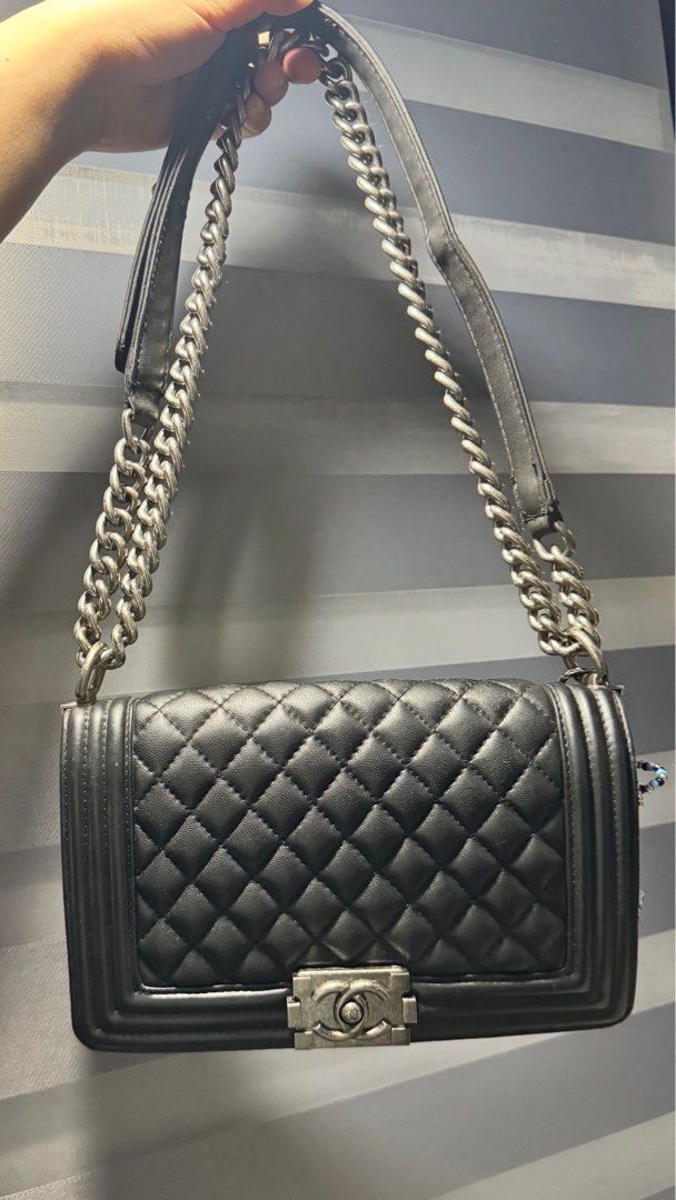 Chanel Black Quilted Boy Bag (Category: Luxury Bags & Wallets) located in Cabanatuan. Submitted by dgbordador (Listing ID 1453659419, Image 1). Description: - Black Quilted Chanel Boy Bag - Silver-tone Hardware - Classic Flap Design with Chain Strap - Versatile for Day or Night Wear - Sign of used.