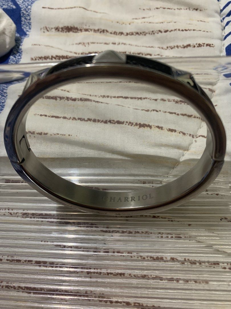 Charriol Original Silver and Black Bangle with Studs (Category: Jewelry) located in Paranaque City. Submitted by declutterby4angels (Listing ID 1453665418, Image 2). Description: - Stylish silver and black bangle - Features a unique woven texture on black sections - Accented with pyramid studs on the sides - Secure and reliable clasp - Perfect as a statement accessory for your wrist.