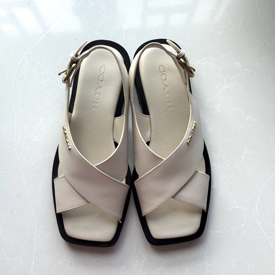 Coach White Leather Crisscross Strap Slingback Sandals (Category: Flats & Sandals) located in Manila. Submitted by averioph (Listing ID 1453692710, Image 2). Description: - Brand: Coach - Color: White - Material: Leather - Design: Crisscross straps, slingback ankle strap, square toe - Details: Gold buckle accent - With minimal flaws shown in photo #9 and #10.