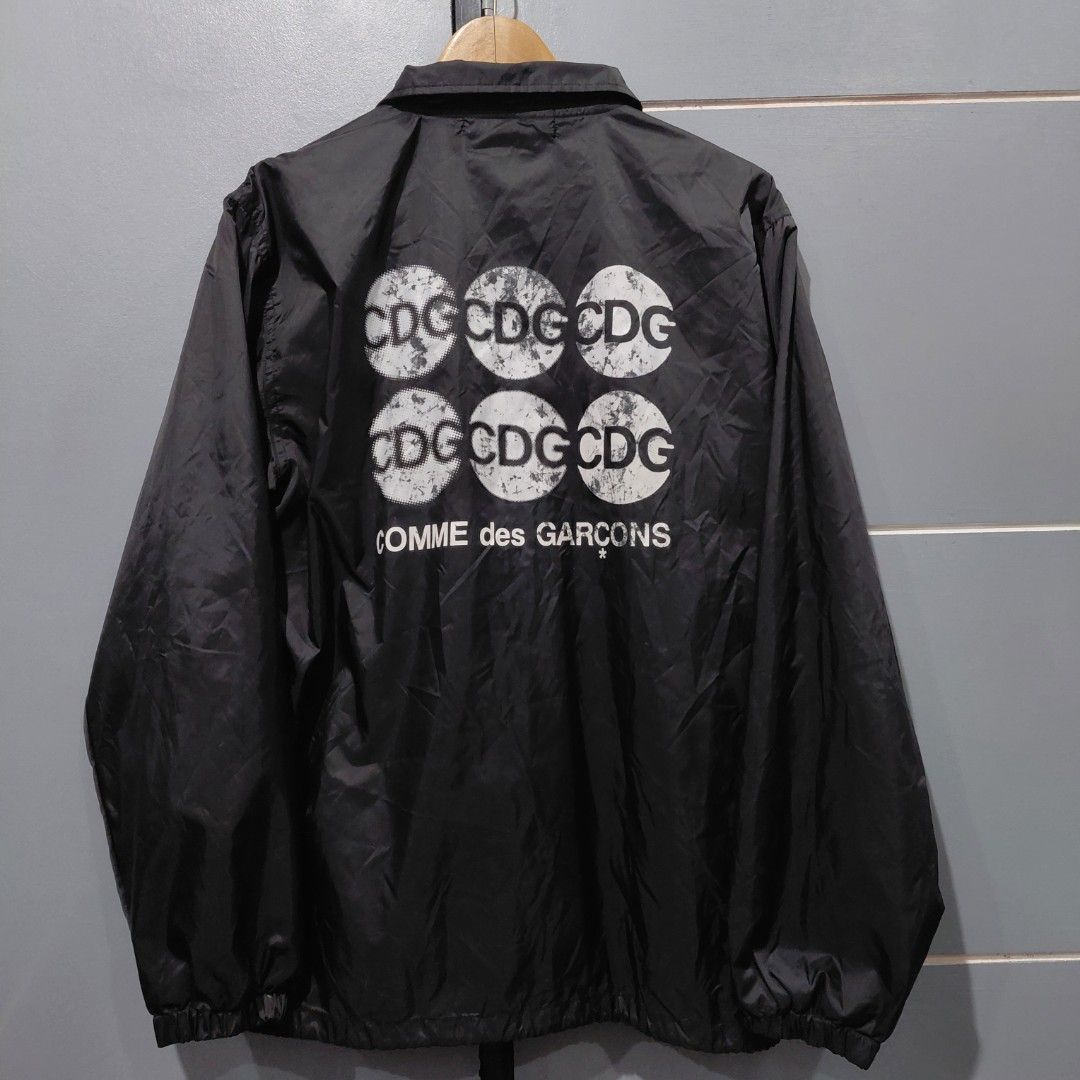 COMME des GARÇONS CDG Black Coach Jacket (Category: Coats, Jackets and Outerwear) located in Manila. Submitted by happywind_ba7b96 (Listing ID 1453645975, Image 1). Description: - Brand: COMME des GARÇONS CDG - Type: Coach Jacket - Color: Black - Size: Tagged L - Features: Iconic CDG logo print on back - Material: Lightweight, ideal for layering - Style: Streetwear.