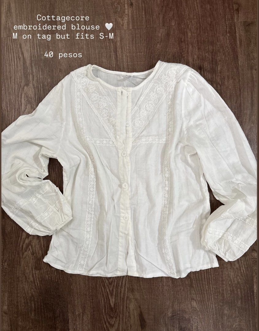 Cottagecore Embroidered Blouse - White (Category: Blouses) located in Rizal. Submitted by decluttch (Listing ID 1453638292, Image 1). Description: - White cottagecore blouse - Features delicate embroidery details - Button-up front closure - Puff sleeves with charming lace trim - Tagged M, fits like a comfortable S-M - Ideal for a cute, vintage-inspired aesthetic - Versatile for casual outings or dressing up.