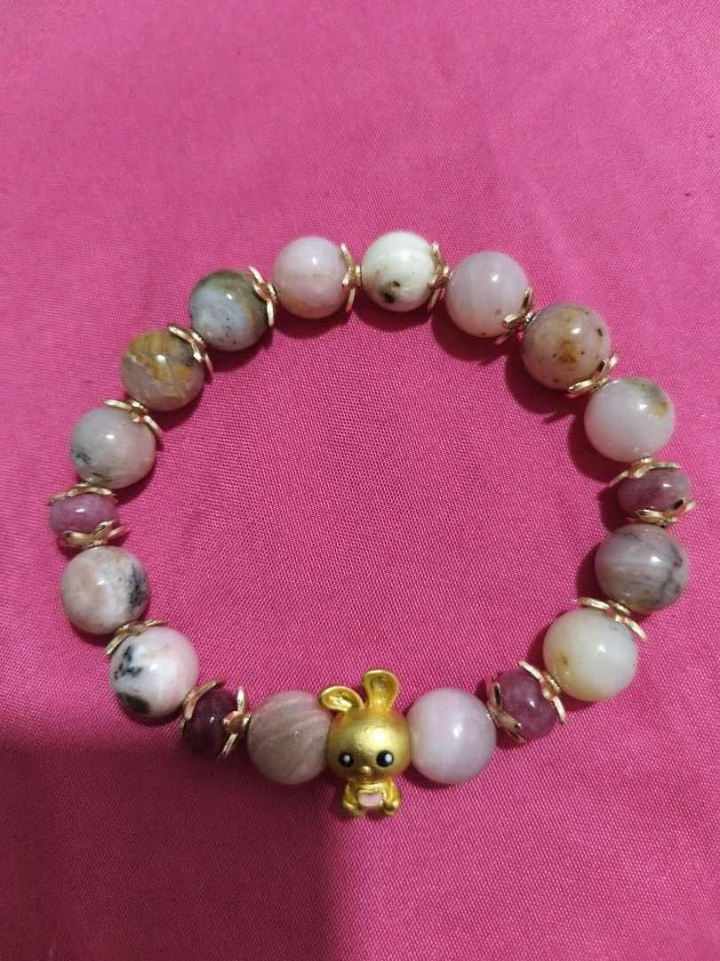 Cute Bunny Charm Beaded Bracelet with Pink Opal (Category: Bracelets) located in Batangas. Submitted by decluttering_bliss (Listing ID 1453757111, Image 1). Description: - Handmade beaded bracelet - Adorable gold bunny charm - Mix of pink and white stones with darker accents - Small pink accent beads - Stretchy band for easy wear - Adds a fun and stylish touch to any outfit.