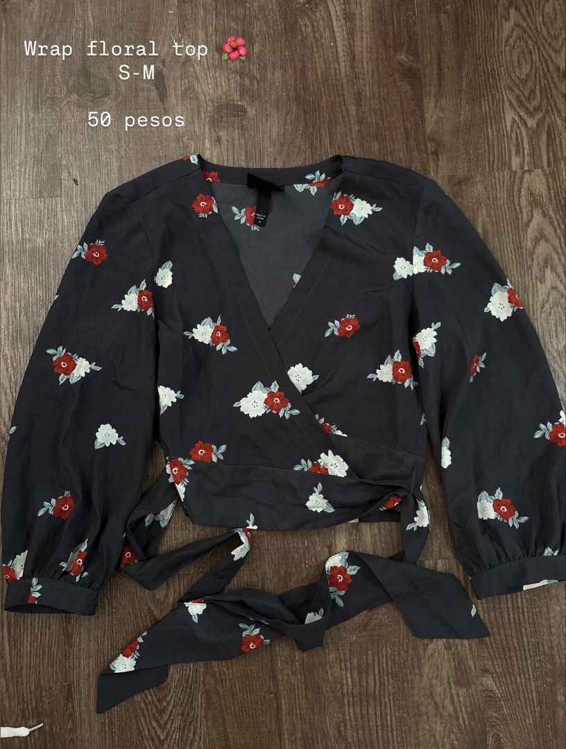 Dark Floral Wrap Top (Category: Blouses) located in Rizal. Submitted by decluttch (Listing ID 1453637751, Image 1). Description: - Cute dark wrap top - Features a red and white floral print - Long sleeves with elastic cuffs - Adjustable tie waist closure - Versatile for casual or dressed-up looks - Fits size Small to Medium (S-M).