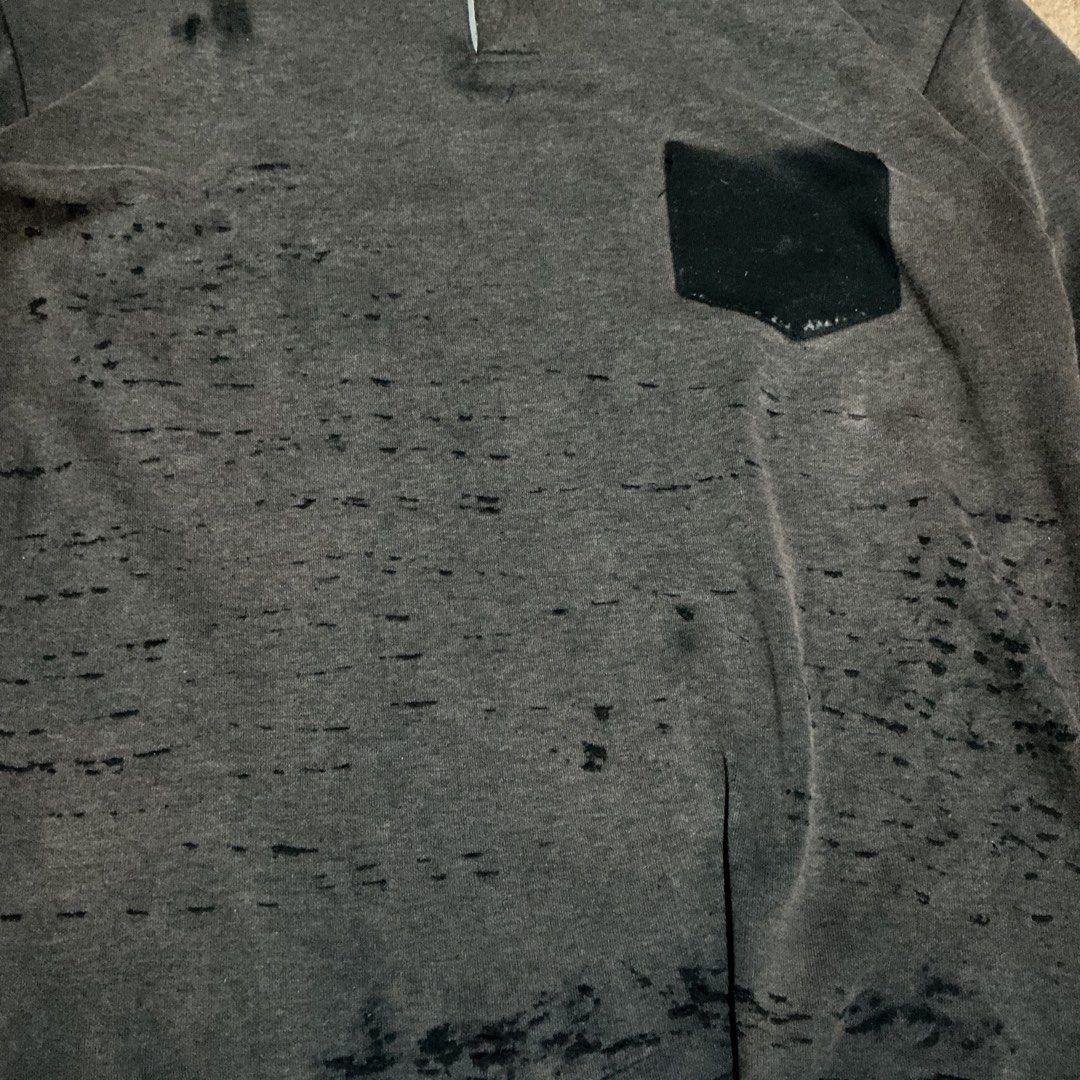 Distressed Grey Long Sleeve Sweatshirt with Pocket (Category: Coats, Jackets and Outerwear) located in Naga. Submitted by eunhasowon12391 (Listing ID 1453755080, Image 3). Description: - Grey long sleeve sweatshirt - Button-up neckline - Chest pocket - Intentionally distressed and ripped fabric - Raw hem with unique bottom detail - Ideal for a streetwear aesthetic.