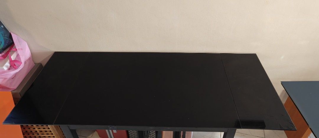 Extendable Dining Table (Category: Tables & Sets) located in Singapore. Submitted by Shikin (Listing ID 1453636050, Image 2). Description: - 110cm × 74 × 76.5cm - Extendable dining table - Sleek black glossy tabletop - Modern design - Easy to clean, tempered glass - with scratches, not for fussy buyer.