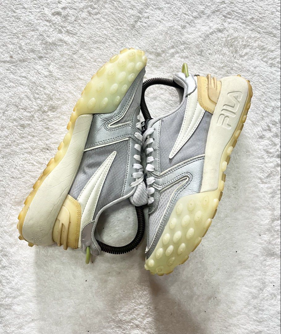 FILA Gara running shoes | Size 36 (Category: Sneakers) located in General Trias. Submitted by zrchustle.604 (Listing ID 1453701883, Image 3). Description: FILA Gara running shoes in a sleek silver-gray and white color palette. Key Design Elements Signature Sole: It features a chunky, semi-translucent gum outsole with prominent nodular treads wrapping up the toe bumper and heel. Upper Material: Crafted with a lightweight mesh grid panel overlaid w